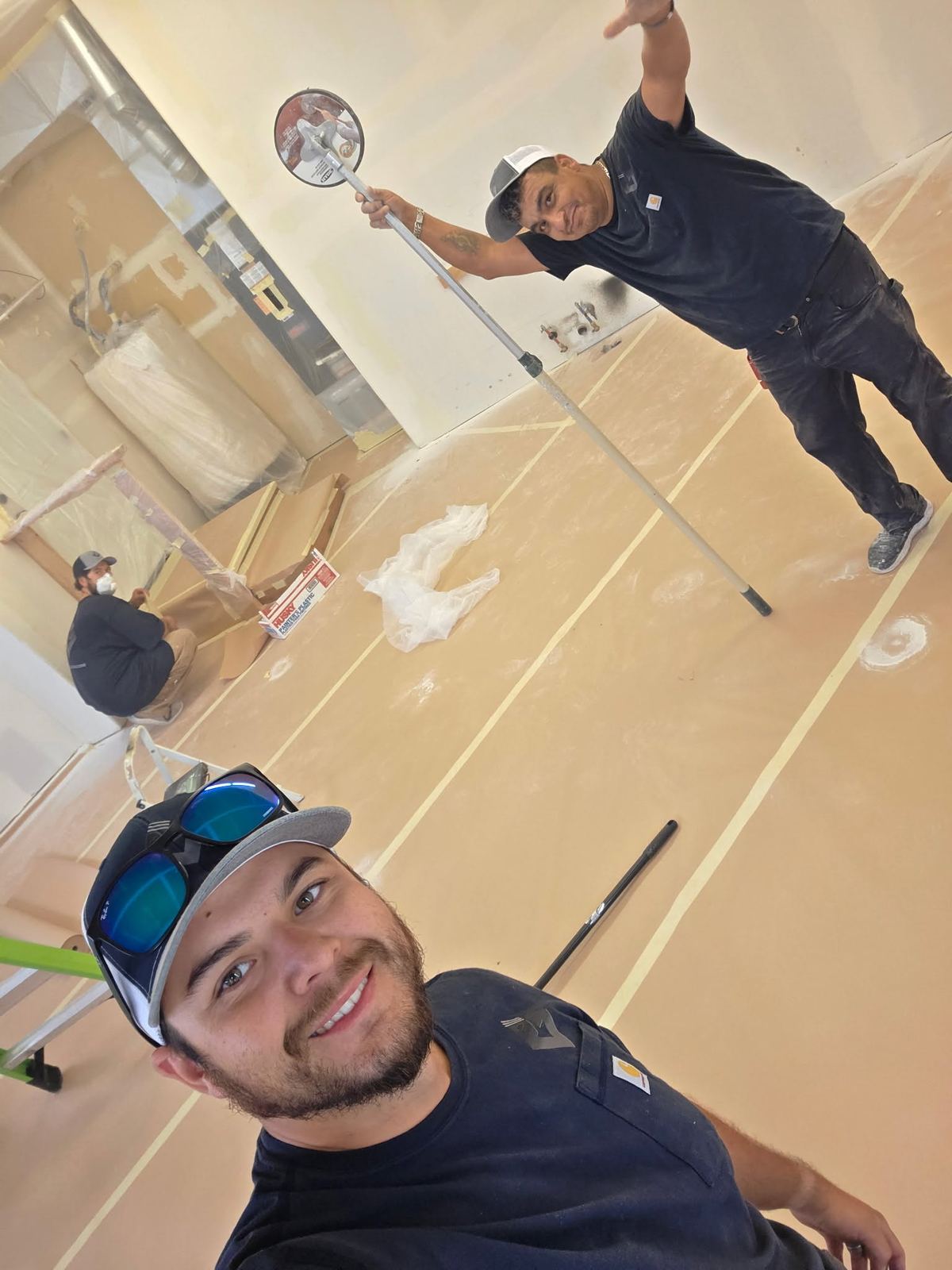 Owner and crew member prepping paint and drywall