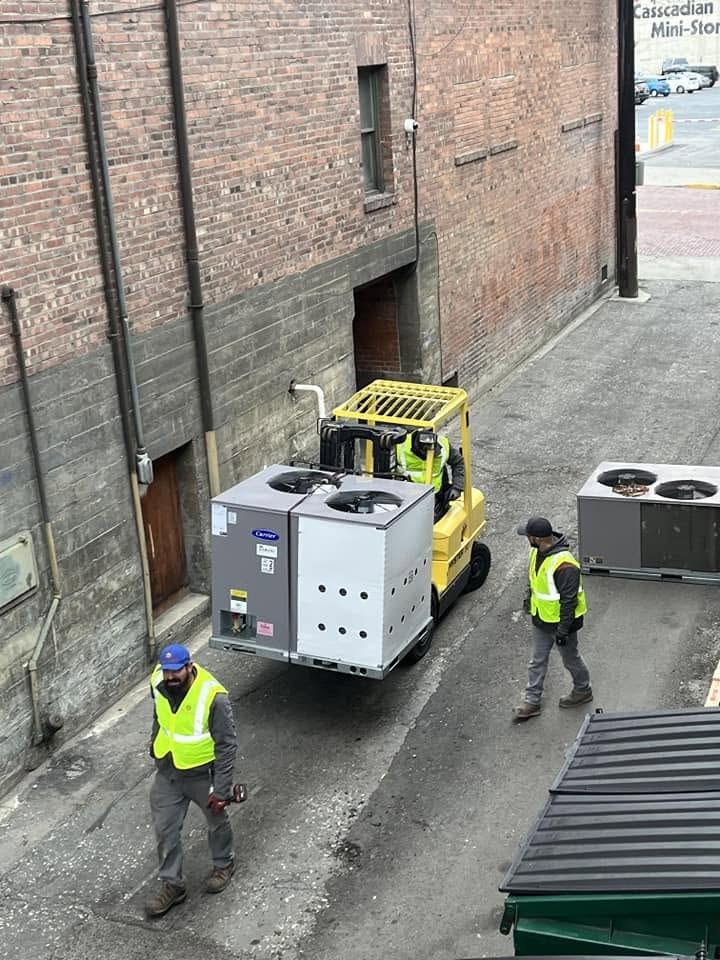Crew installing a commercial rooftop HVAC unit