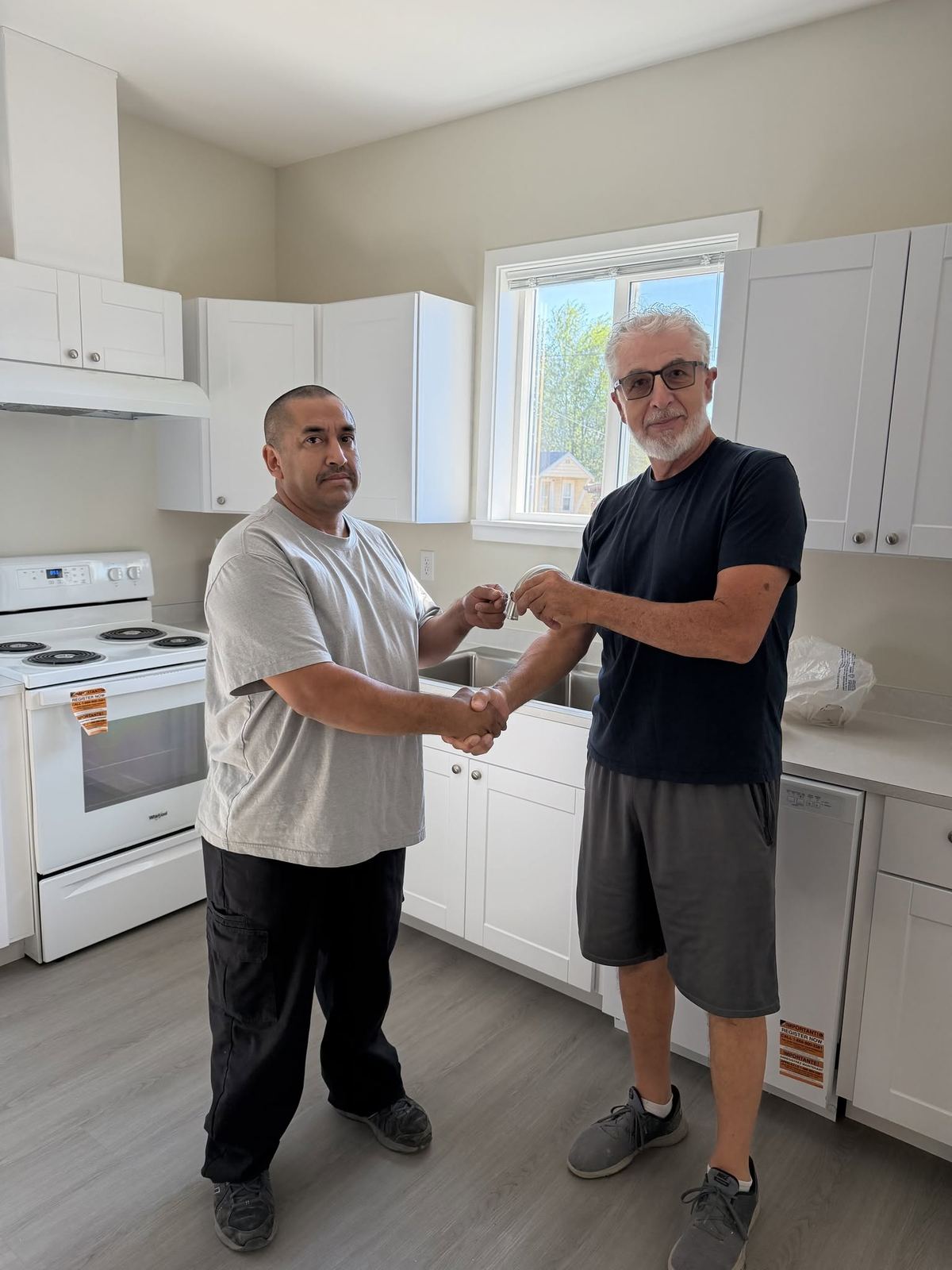 Homeowner receiving keys with the construction manager